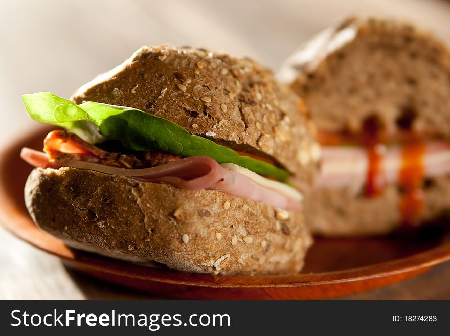 Sliced ham sandwich with tomato on a mixed seed bread