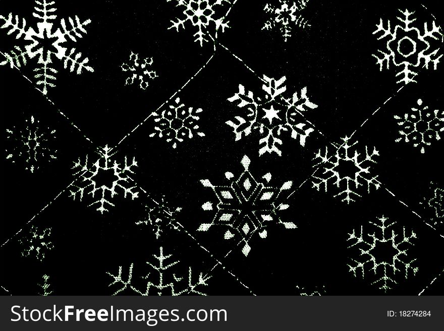 Photo of a snowflake printed material, in black and white. Photo of a snowflake printed material, in black and white.