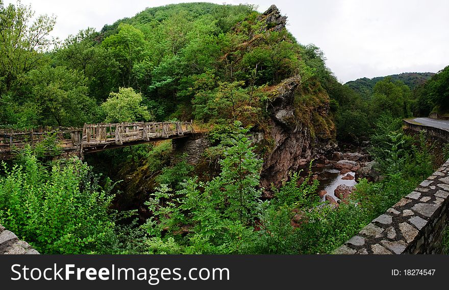 Rickety wooden bridge over a small french mountain stream. Panorama of 6 pictures. Rickety wooden bridge over a small french mountain stream. Panorama of 6 pictures.