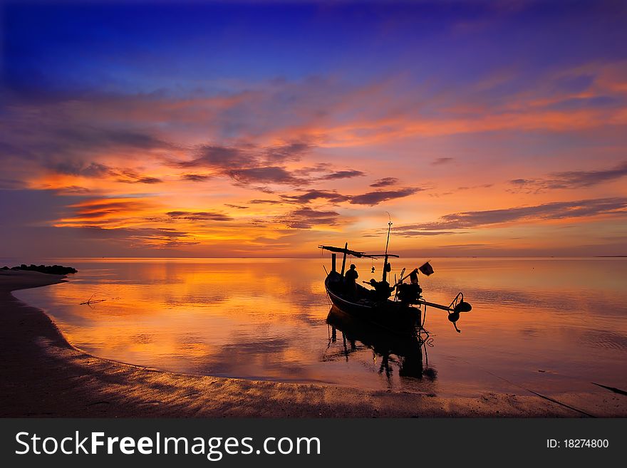 Sunrise and Fishermen boat silhouette in Thailand