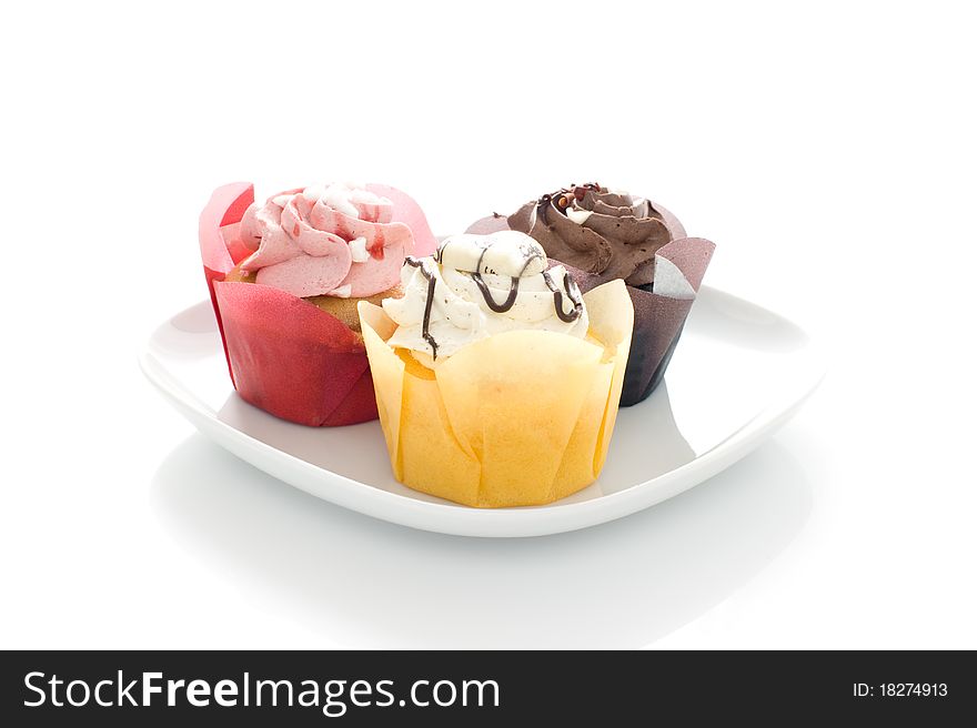 Three colored Muffin on a white plate