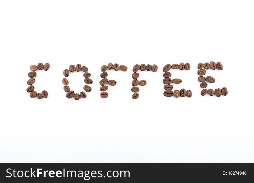 Coffee beans are laid out in the word
