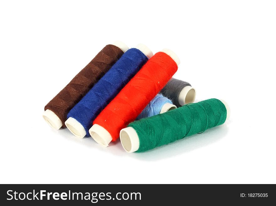 Bobbins of colored thread isolated on white