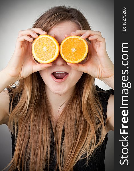 Girl Using Orange As Eyes, With Grey Background