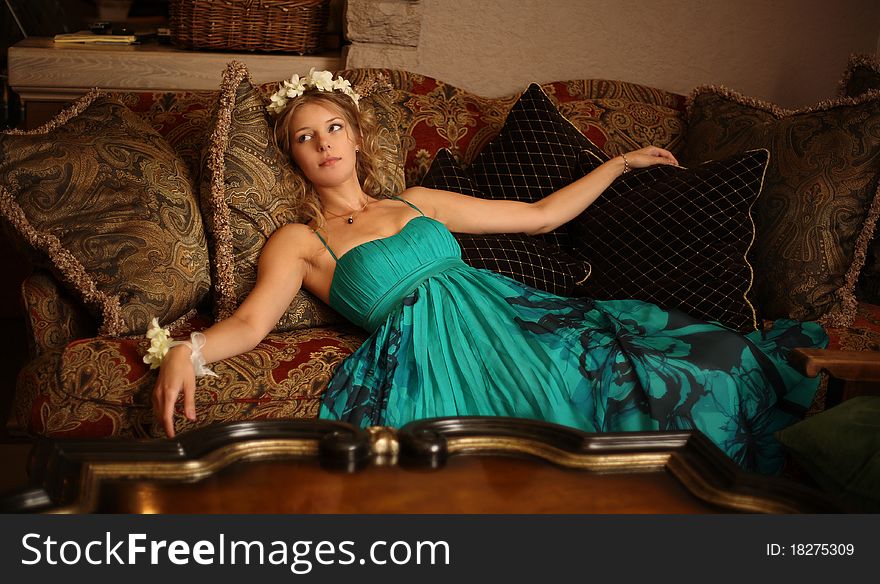 The girl having a rest on a beautiful sofa. The girl having a rest on a beautiful sofa
