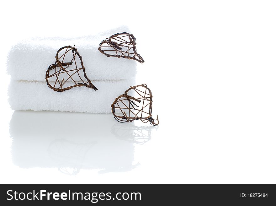 A stack of white towels with woven hearts. A stack of white towels with woven hearts
