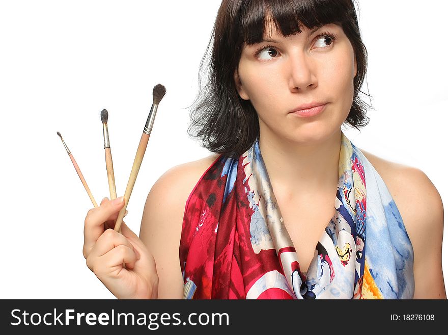 Beautiful thoughful girl holding brushes and smiling. Beautiful thoughful girl holding brushes and smiling.