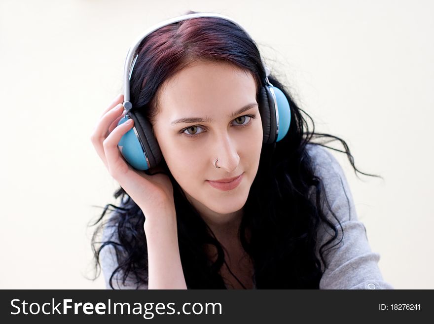 Caucasian dark haired woman with earphones portrait