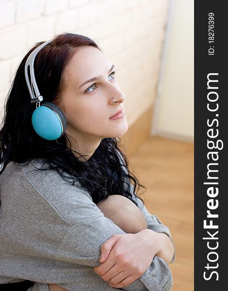 Caucasian dark haired woman with earphones
