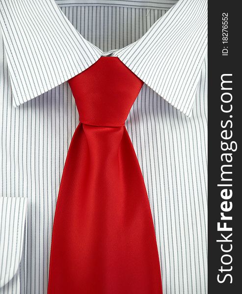 Close-up of new shirt with red silk necktie. Close-up of new shirt with red silk necktie