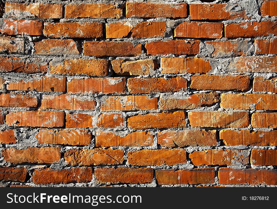 One part of an old orange brick wall.