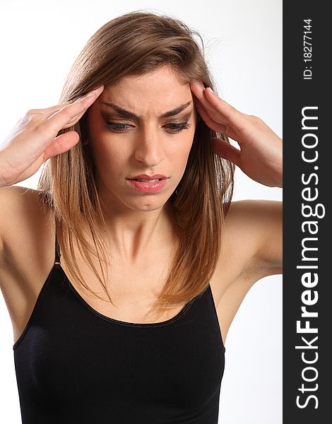 Headshot of beautiful young woman, hands raised to forehead and face showing anguish of a headache. Headshot of beautiful young woman, hands raised to forehead and face showing anguish of a headache.