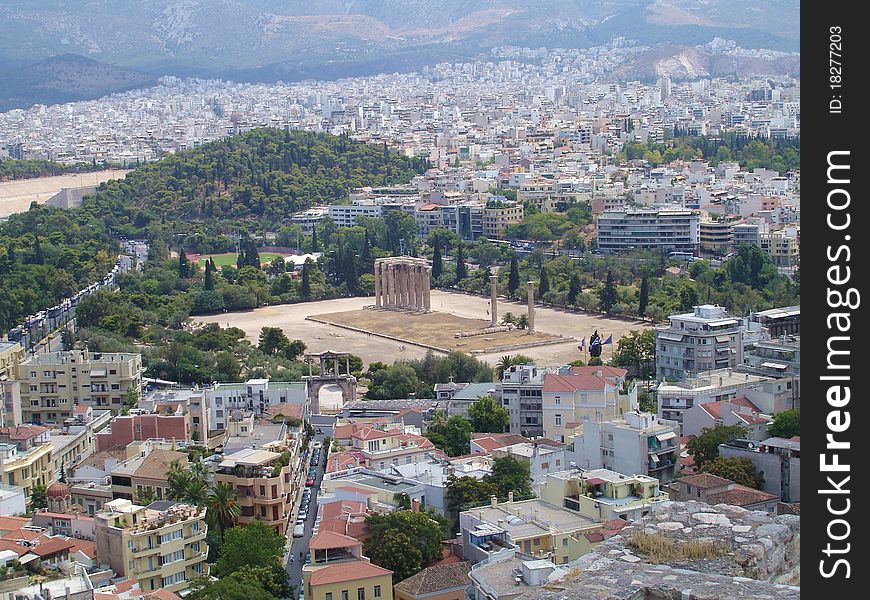 A view of Athen's houses with the remaining pillars of the big Zeus' temple in the centre of it seen from the acropolis. A view of Athen's houses with the remaining pillars of the big Zeus' temple in the centre of it seen from the acropolis