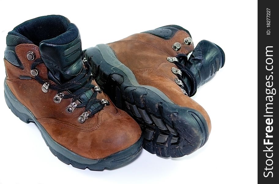 A pair of brown leather hiking boots on a plain white background. A pair of brown leather hiking boots on a plain white background