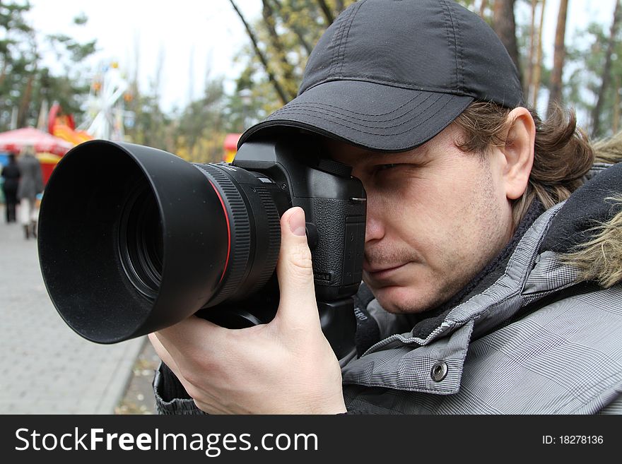 Photographer man with modern camera and lens