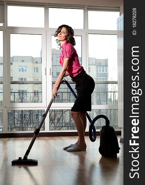 Woman doing housework with vacuum cleaner. Woman doing housework with vacuum cleaner