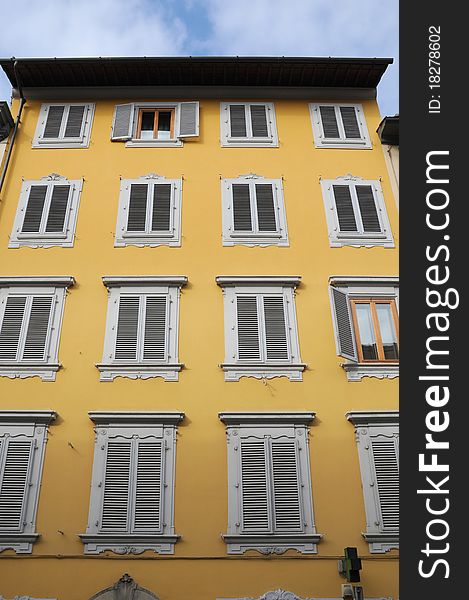 Shuttered windows on an old yellow building in Florence Italy