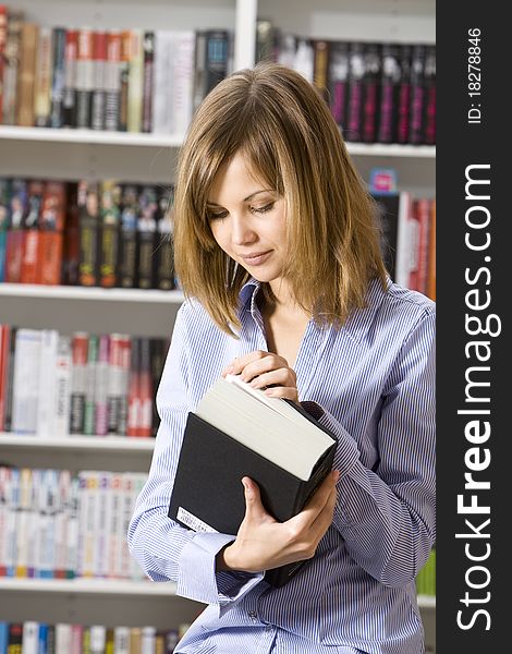 Young woman with big book in the library. Young woman with big book in the library