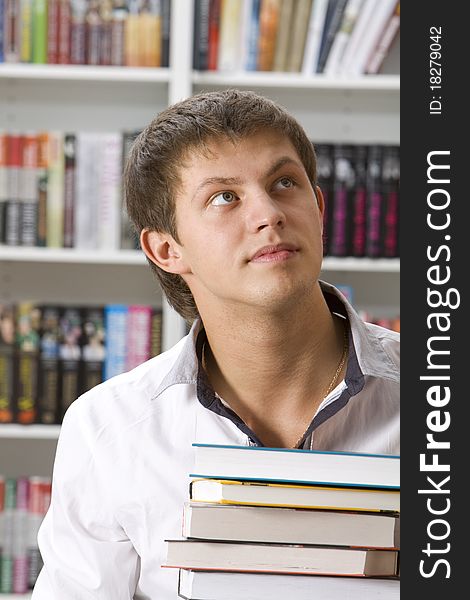 Student sitting with books in the library. Student sitting with books in the library