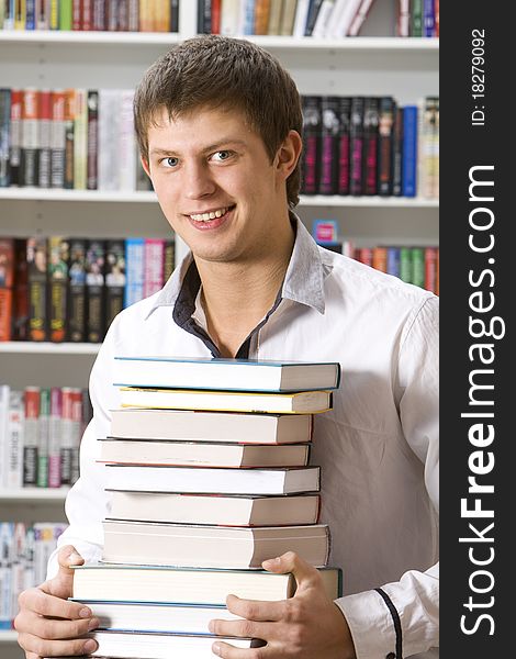 Student sitting with books in the library