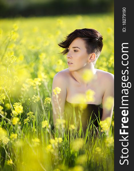 Young beautiful woman in yellow flower field. Young beautiful woman in yellow flower field.