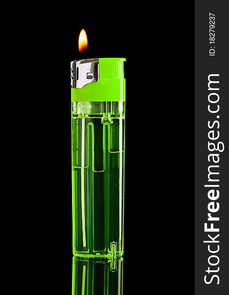 Lighter and fire on black background