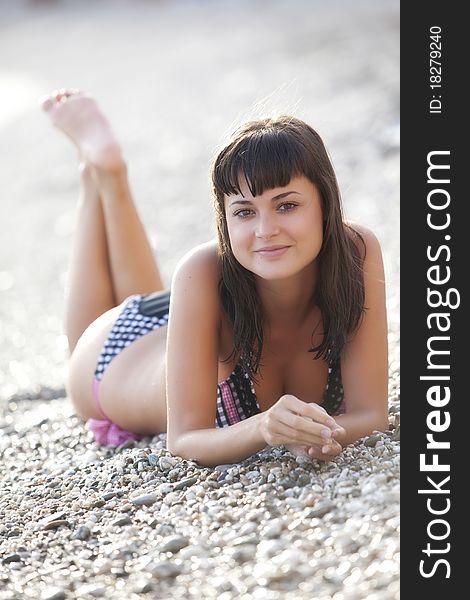 Young beautiful girl posing on the beach. Young beautiful girl posing on the beach