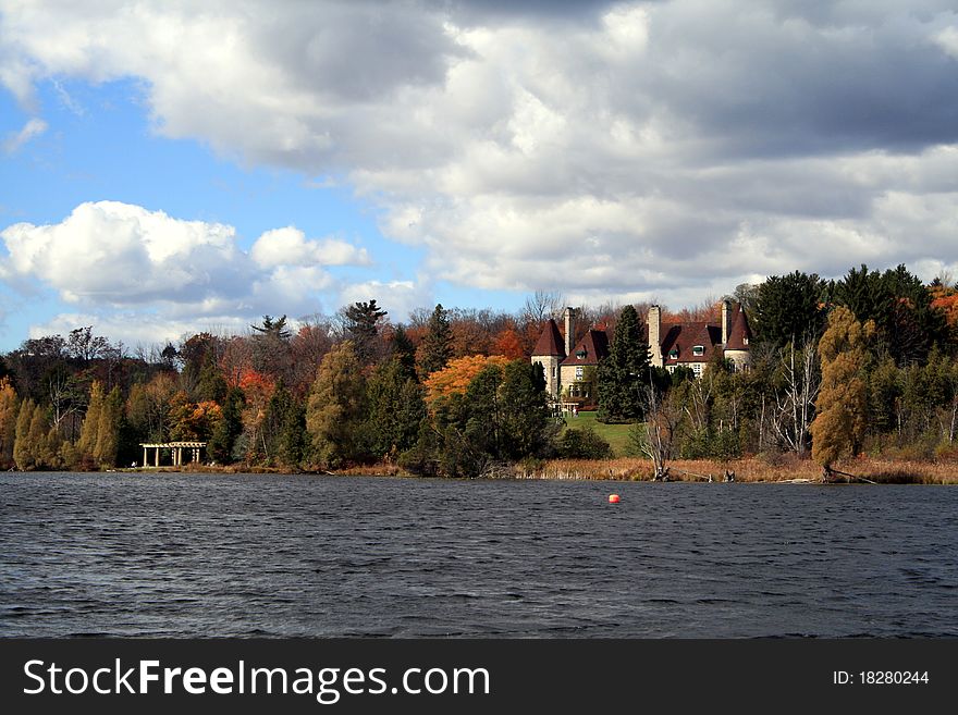 Autumn landscape with a castle on the lake shore