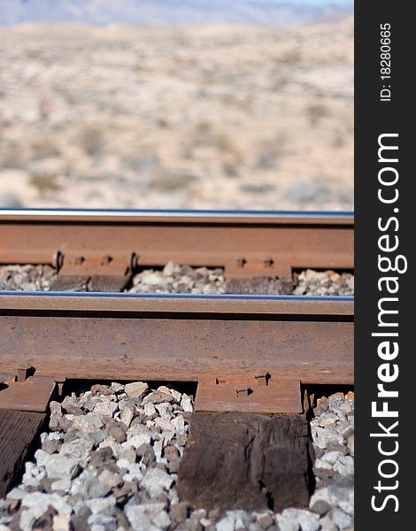 A photograph focused on the railroad metal track. A photograph focused on the railroad metal track.