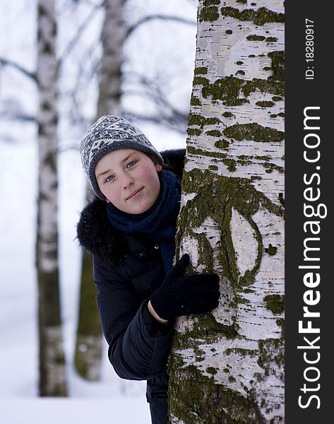 Young Girl Looks Out From The Tree