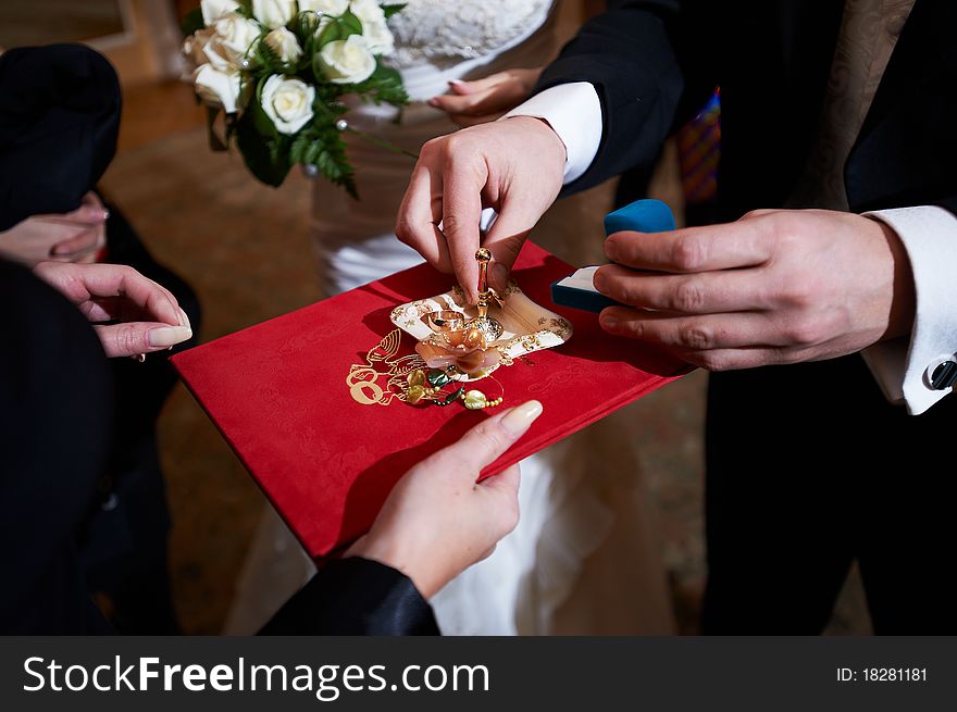 Groom and wedding rings on ceremony of marriage