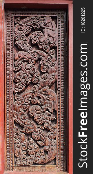 Decorated wooden beside door in Buddhist temple, Laos