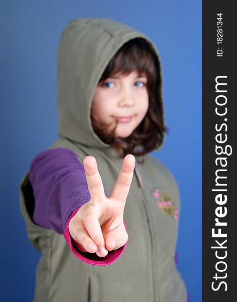 Little child making peace sign