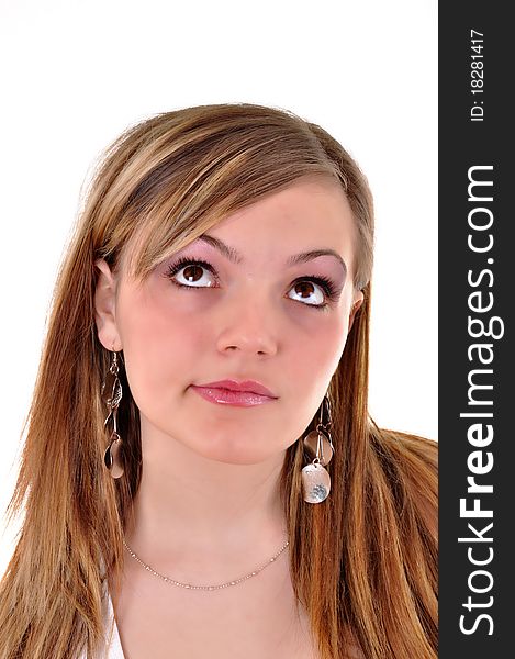 Close-up portrait of a beautiful teenager. Looking up into the corner. Lots of copyspace and room for text on this isolate.