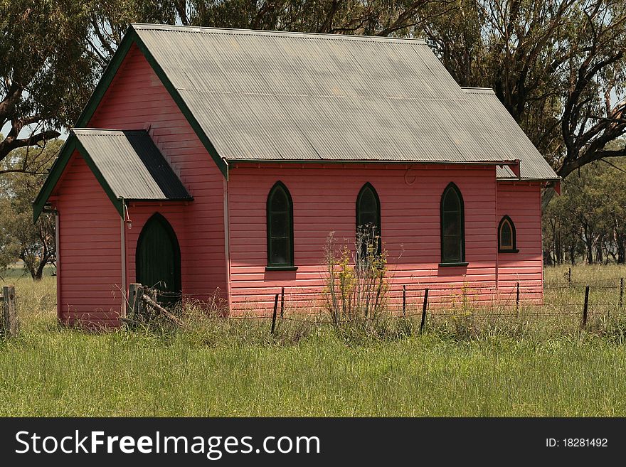 Old Pink Church on the side of the Road sitting in a paddock