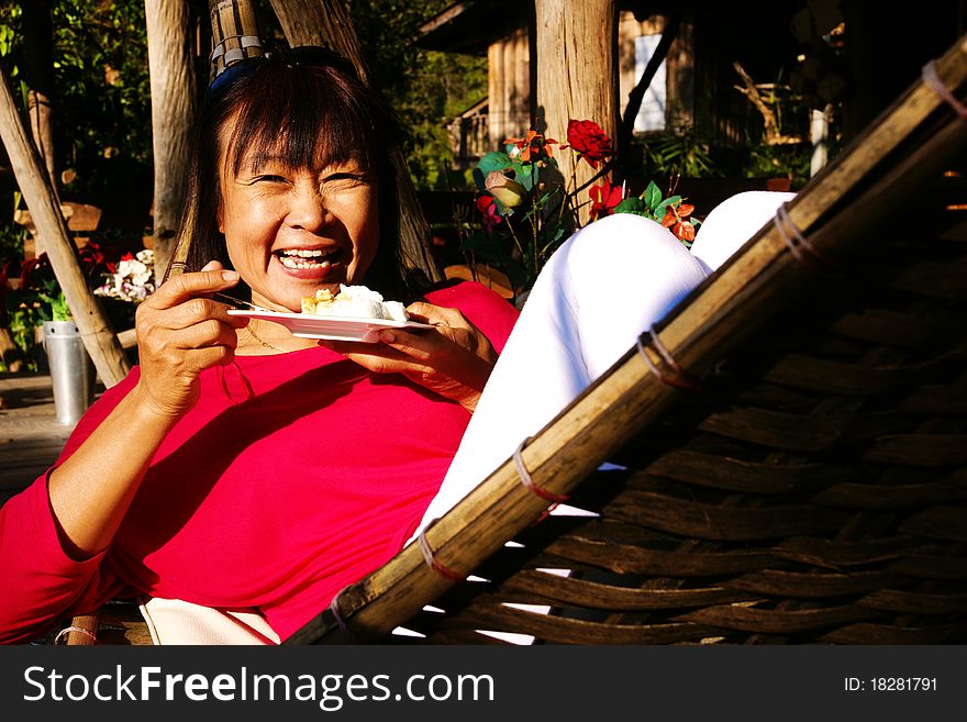 Woman laughing at dish of food. Woman laughing at dish of food