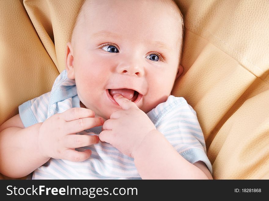 Portrait of cute happy blue-eyed laughing baby-boy, studio shot. Portrait of cute happy blue-eyed laughing baby-boy, studio shot
