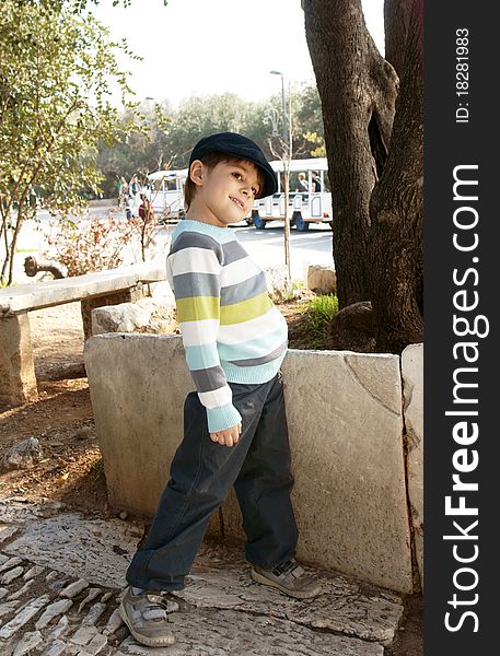 Full-length portrait of stylish smiling little boy, outdoor shot. Full-length portrait of stylish smiling little boy, outdoor shot