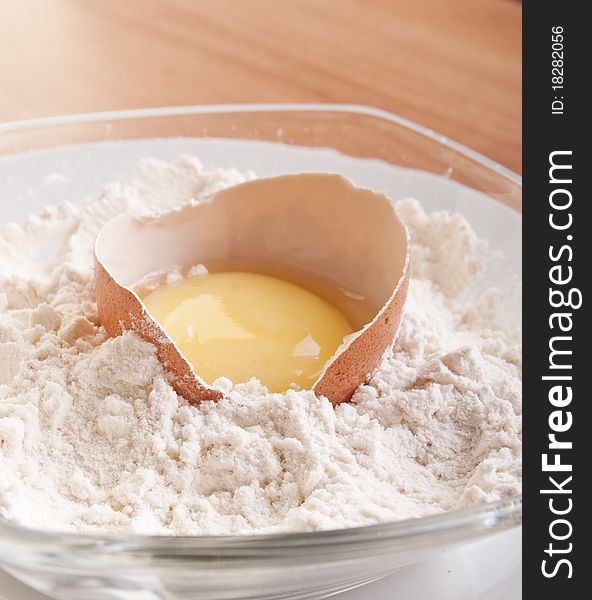 Broken egg with shell on flour