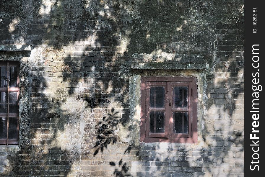 Wooden windows attached on aged wall in sun shine shadow. Wooden windows attached on aged wall in sun shine shadow.