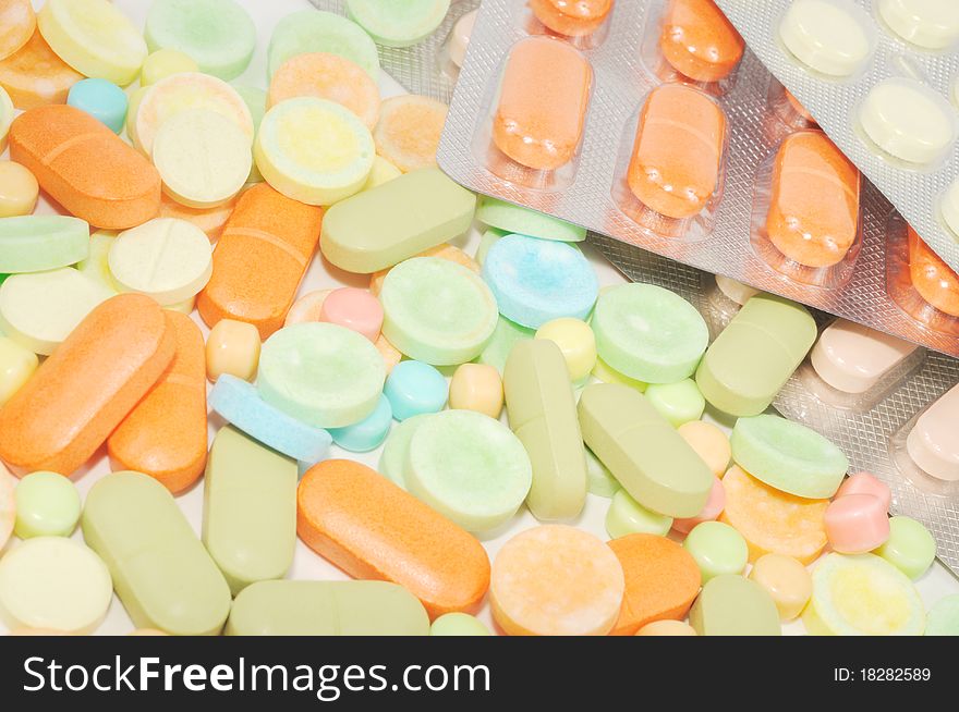 Colorful pillsand blisters on a white background