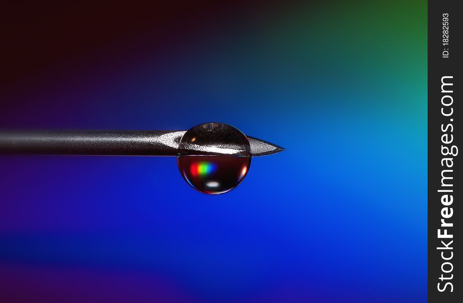 Medical syringe needle with a drop of colored