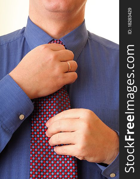 Businessman adjusting his tie blue