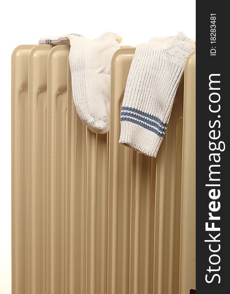 Oil radiator drying isolated pair of socks - Heatings on a white background. Oil radiator drying isolated pair of socks - Heatings on a white background