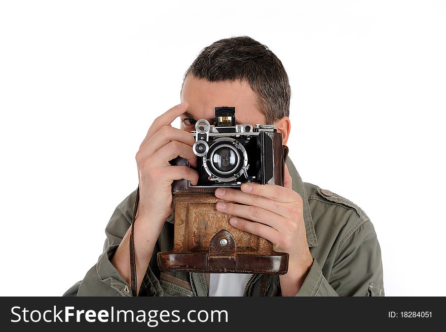 Young professional photographer with old retro film camera. isolated on white background