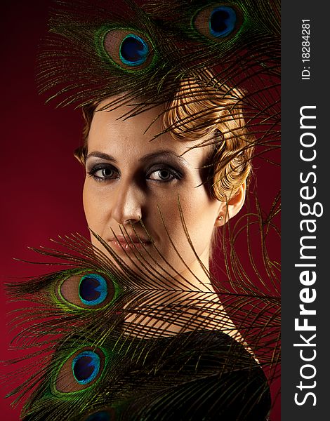 Vertical portrait of elegant woman with feather