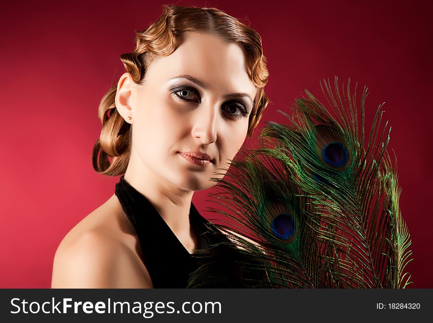 Portrait of elegant woman holding feather