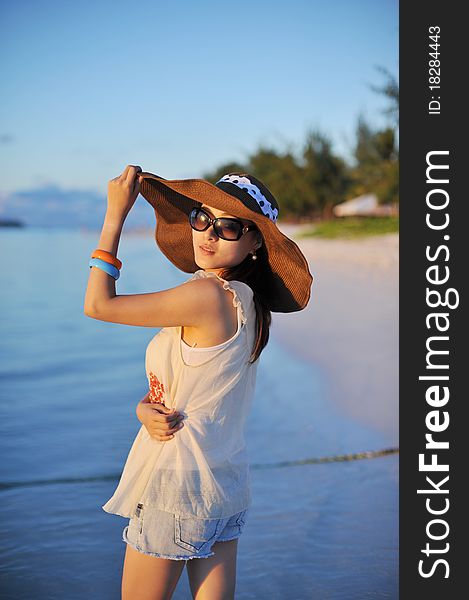 Girl on the beach of Saipan Island with the beautiful sunset. Girl on the beach of Saipan Island with the beautiful sunset.