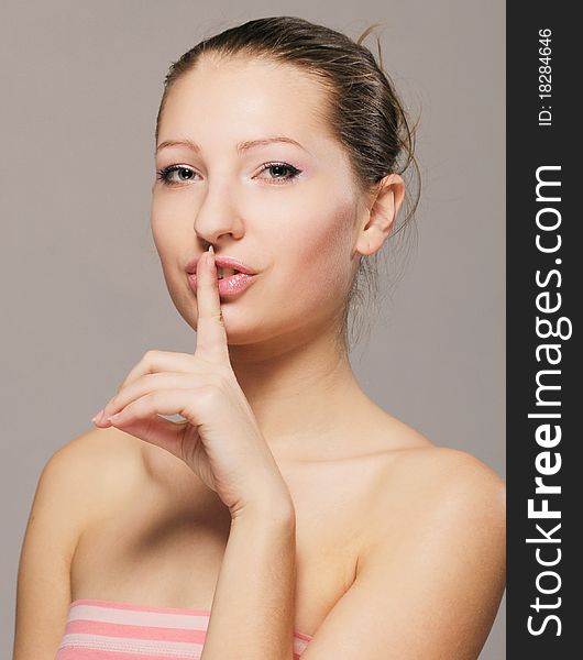 Portrait of a beautiful girl with his finger near the lips. Portrait of a beautiful girl with his finger near the lips