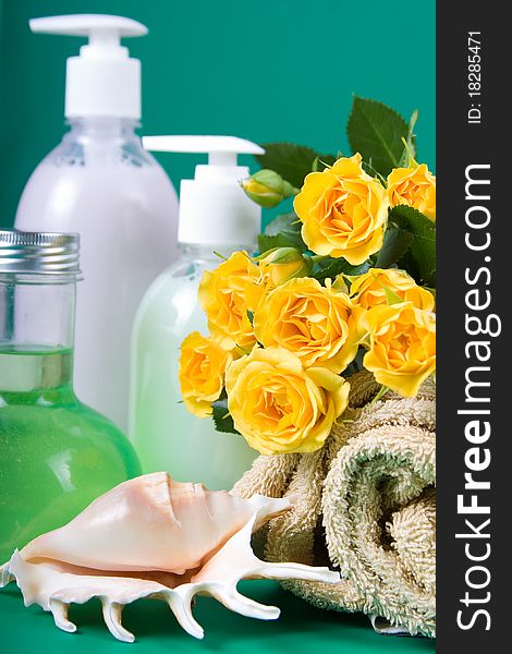 Spa still life with yellow roses on a green background